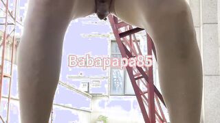 sissy dressed in high high-heeled shoes and jeans top at the construction website trio